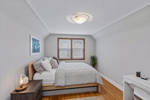 Upper-level bedroom with hardwood floors and flexible space for work or relaxation.