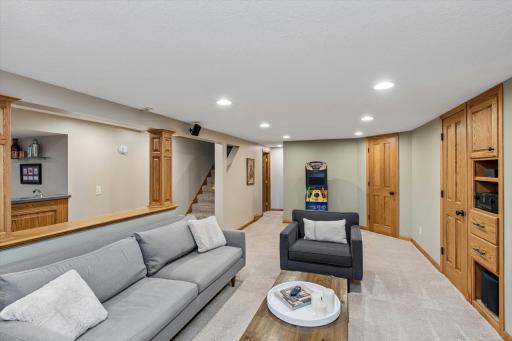 Relax by the fireplace, host game days at the wet bar, and enjoy movie nights in this spacious lower-level retreat. With custom built-ins, abundant lighting, and room for family and friends, this home offers the perfect blend of comfort and entertain