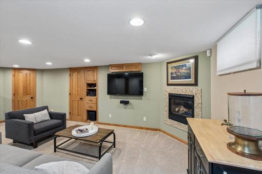 Entertain with ease in the finished lower level featuring a fireplace, custom built-ins, wet bar, beverage cooler, and spacious family roomâperfect for game days, movie nights, and year-round enjoyment