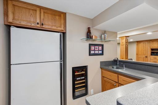 This lower wet bar that adds meaningful entertainment value. It offers the convenience of a second refrigerator, sink, wine storage, and seating area, making the basement feel like a destination rather than just extra square footage