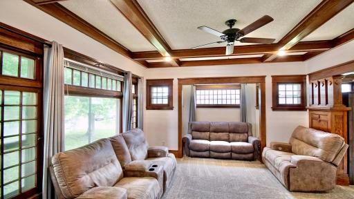 Living room with gorgeous natural woodwork and coffered ceiling. This home is a true gem!