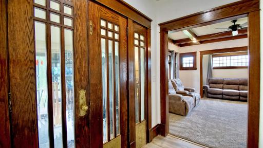 Mud room area at front entry of home. Leaded glass windows, wood trim, and French doors are all in keeping with the historic charm of this 1915 era home.
