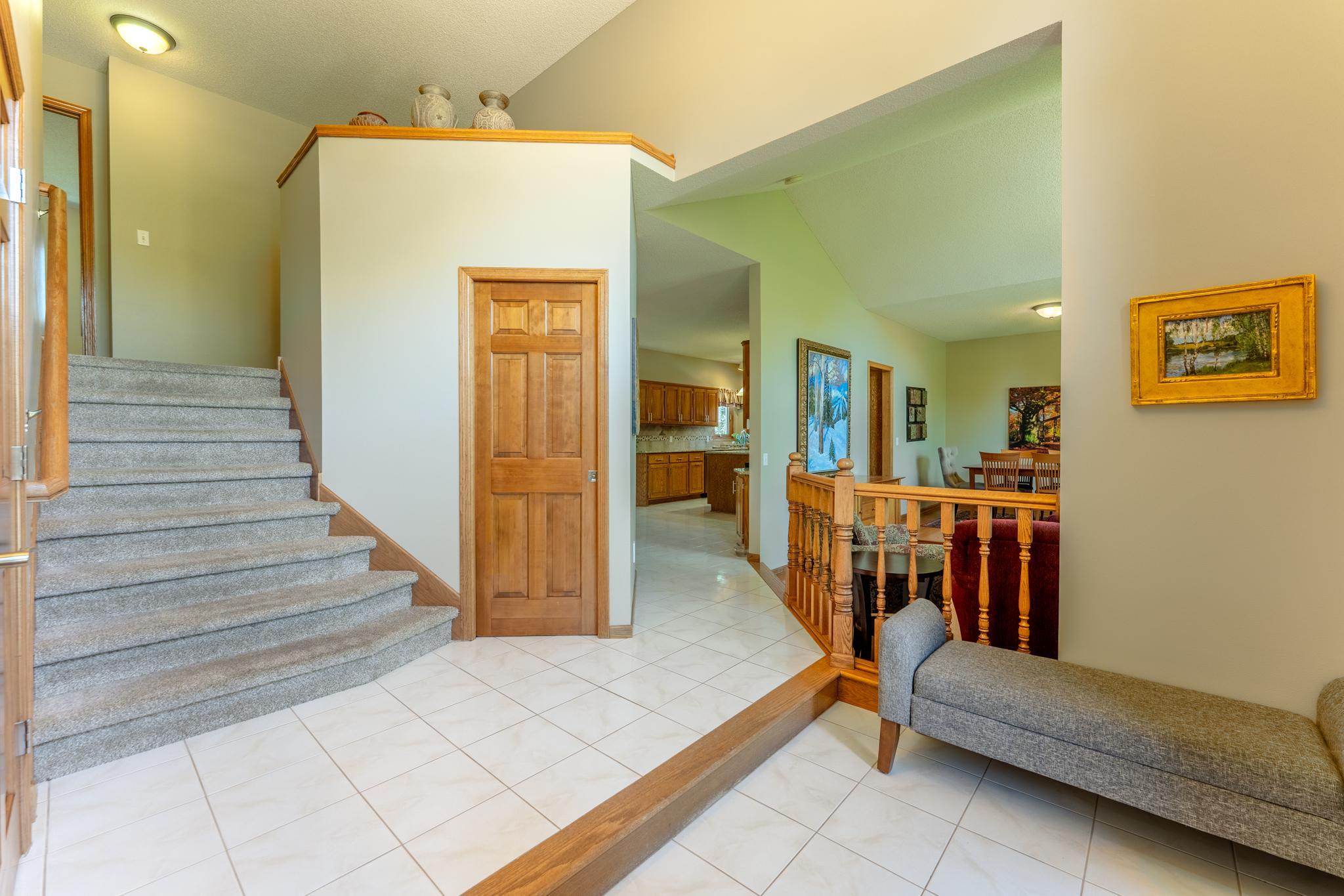 The tiled foyer offers easy access to the upstairs, living spaces, and kitchen, with a smart, functional layout that connects the whole home.