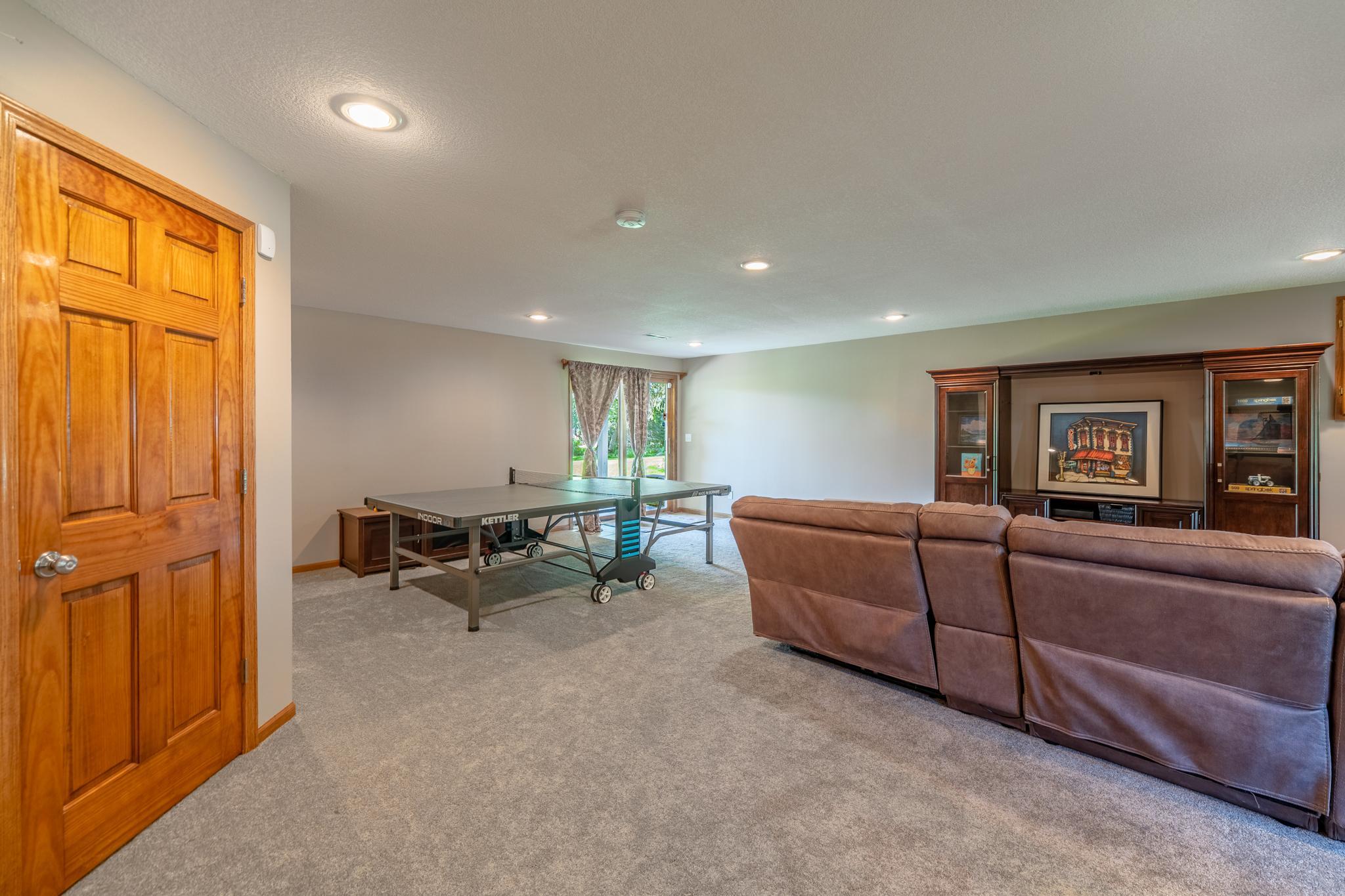 This does not have a basement feel at all with light from the front windows and sliding doors leading out to the covered patio.