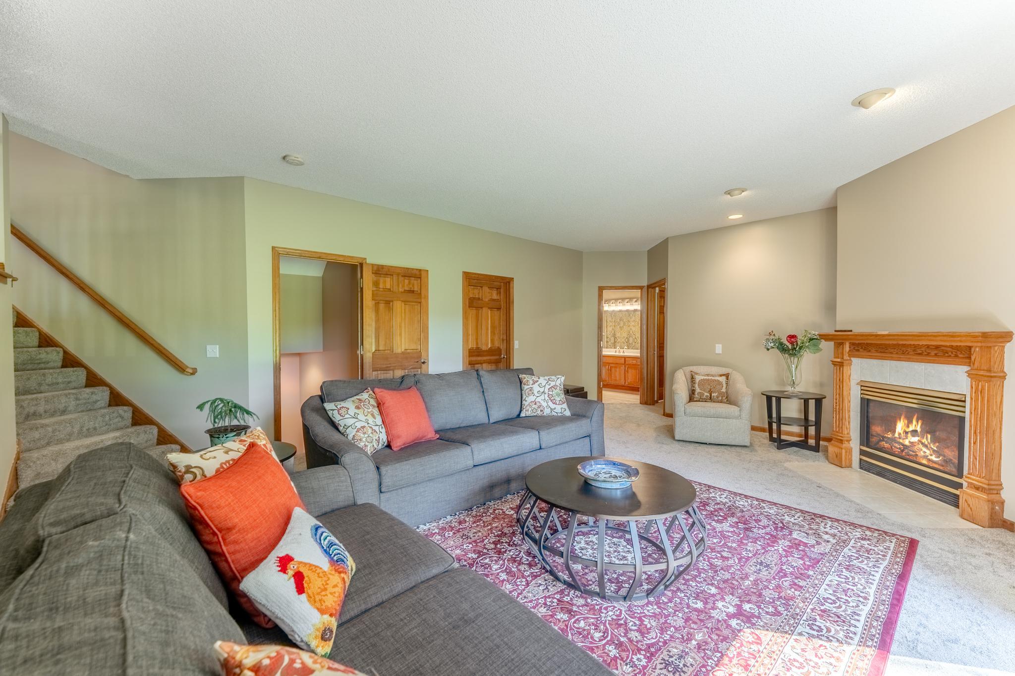 The family room is anchored by the warmth of the fireplace on cold winter evenings, and a great place to relax and keep cool with views of the backyard on the hot summer days.