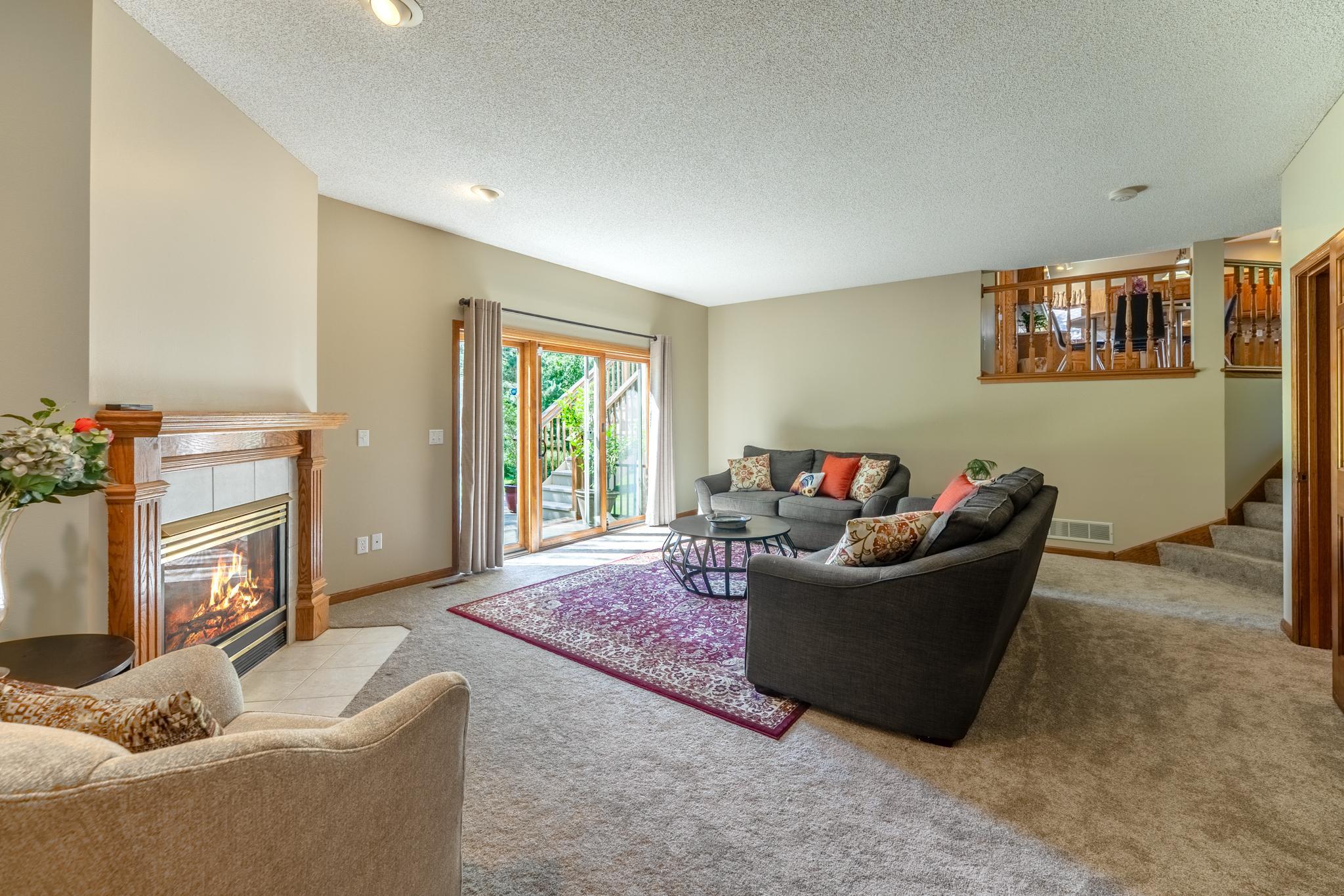 The family room features new carpet and fresh paint, along with sliding doors leading out to the paver patio and backyard.