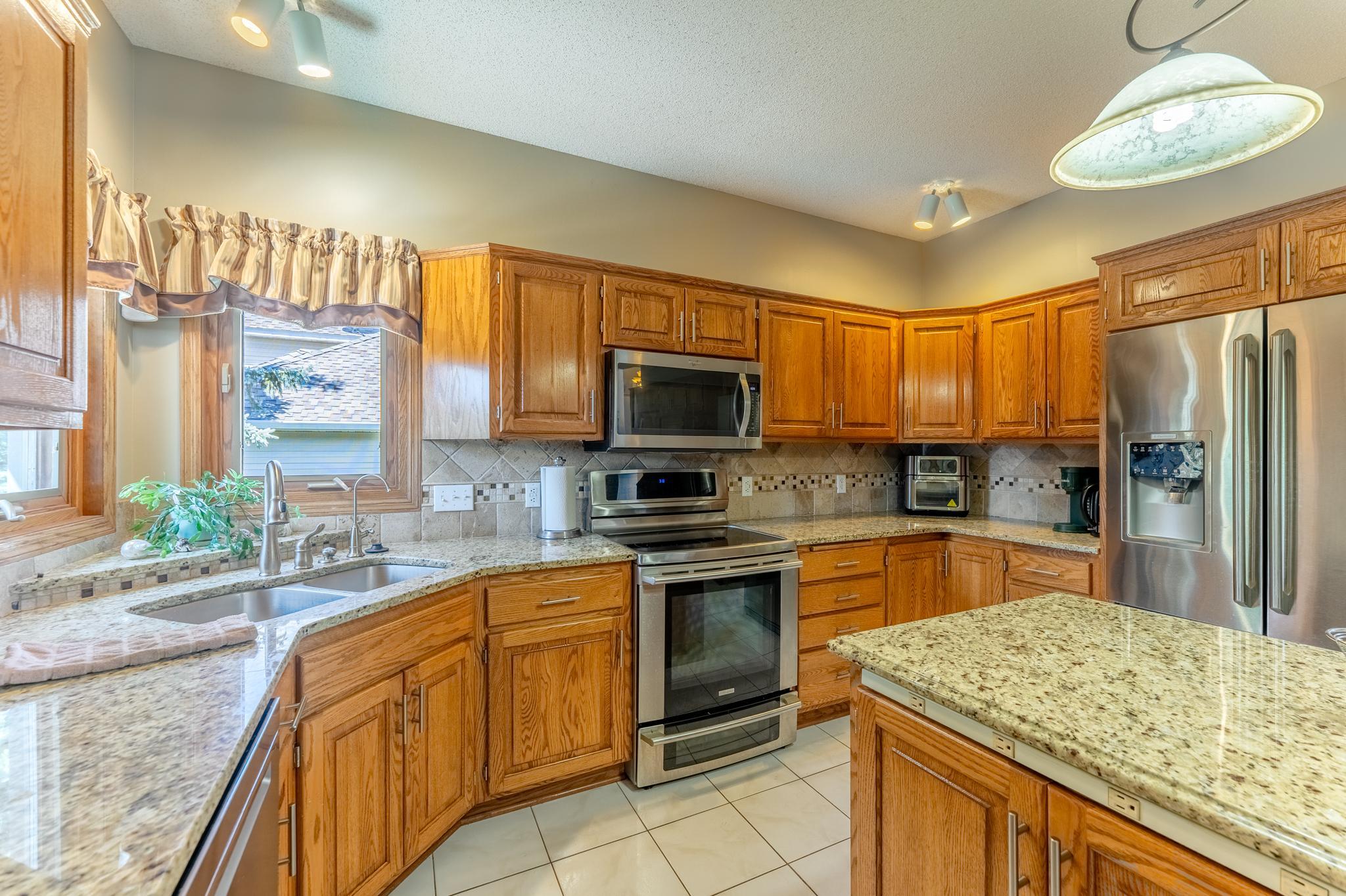 With granite countertops, stainless steel appliances, and a bright kitchen window, this space is a cook's dream.