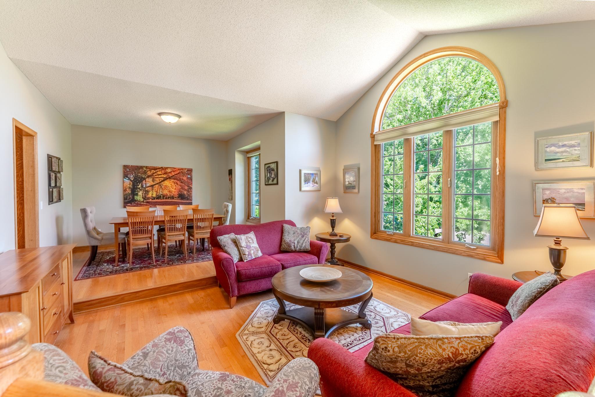 Beautiful hardwood floors and large windows make this living space warm and inviting.