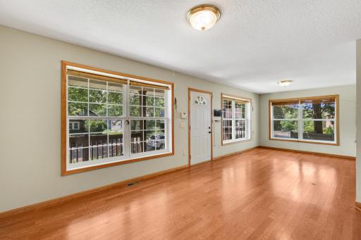Sun-filled living room with expansive windows and beautiful flooring.