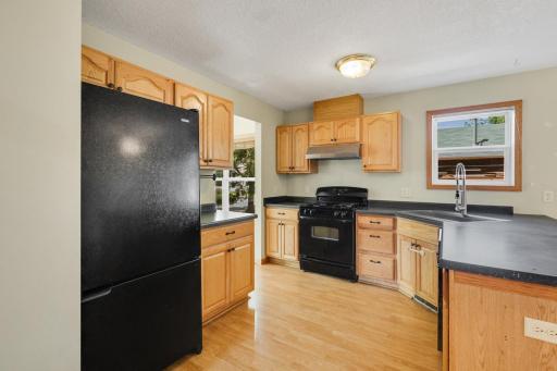 Functional kitchen with tons of cabinetry, generous counter space, and breakfast bar seating.