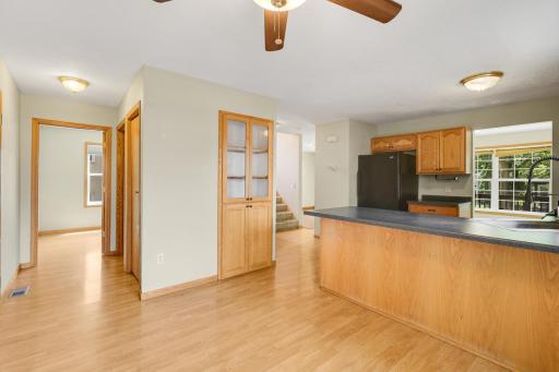 Open kitchen with breakfast bar and built-in display cabinet.