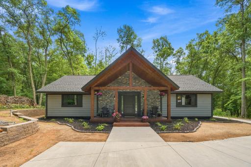 Custom built new construction home featuring welcoming 8'x20' covered porch with rough sawn pine, ledgestone backdrop and stained pine.