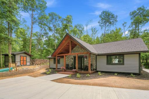 Stained 2'x8' log siding with matching storage shed and garage. Beautifully landscaped with sod to be put added.