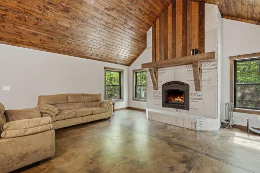 Stone will be added to the stained pine accents on the fireplace.