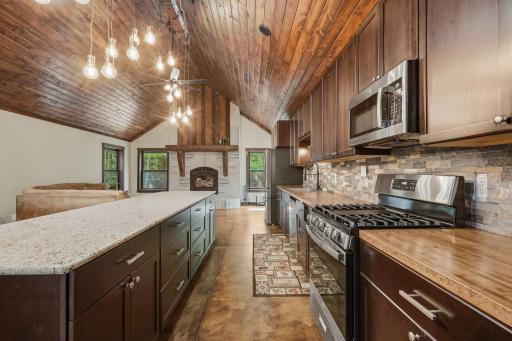 The large kitchen island features granite countertop and lots of storage below.