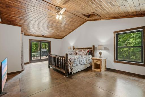 Huge primary bedroom with private access to the rear deck and backyard.