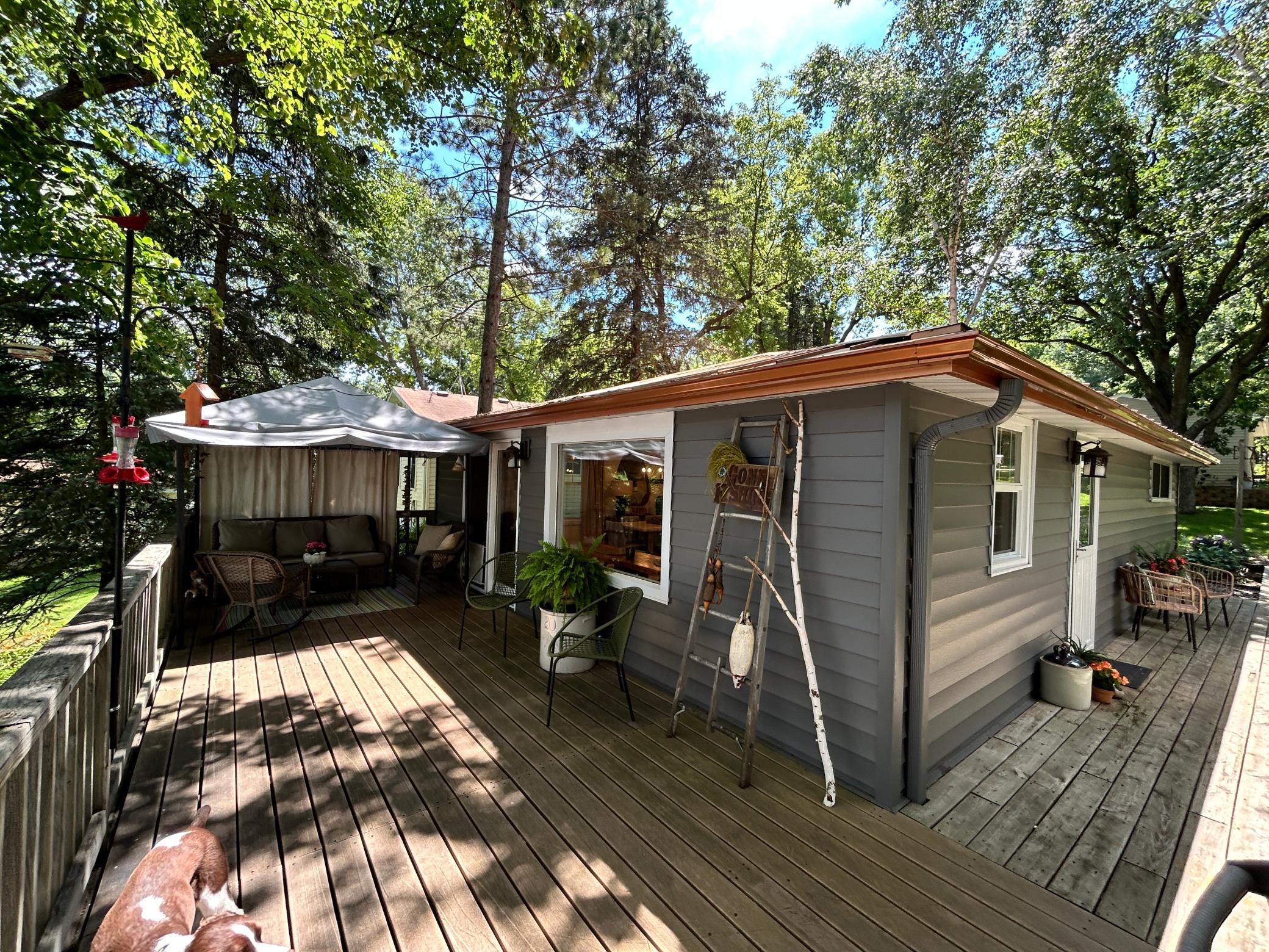 Lakeside of main level offing great views of the lake from the inside as well as the wrap around deck. This also highlights newer metal roof.