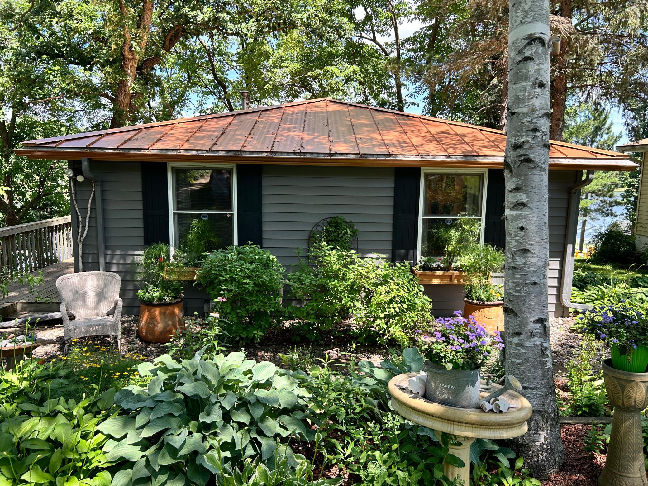 The front of the home welcomes you home with this beautiful flower garden.