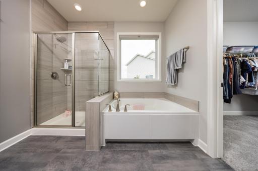 Luxurious soaking tub and spacious shower in the primary bathroom