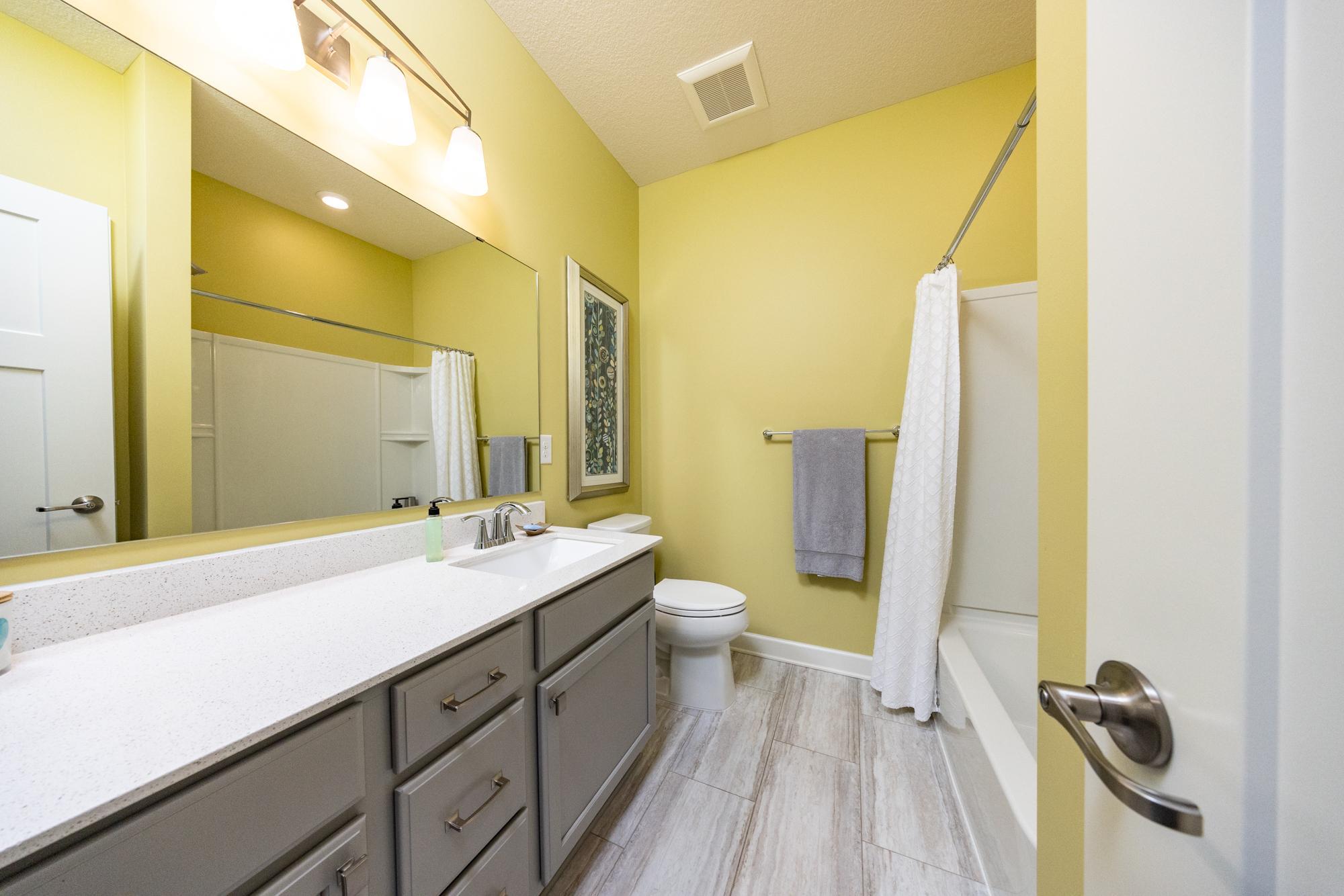 Main floor full bathroom thoughtfully placed between the second and third bedroom