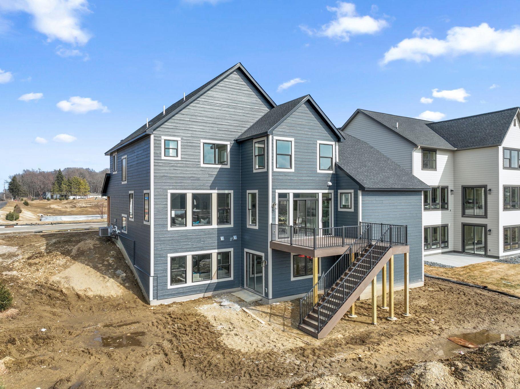 Exterior walk-out. Deck not included. Landscaping is included. This is not the actual home, but a model of the same floorplan.