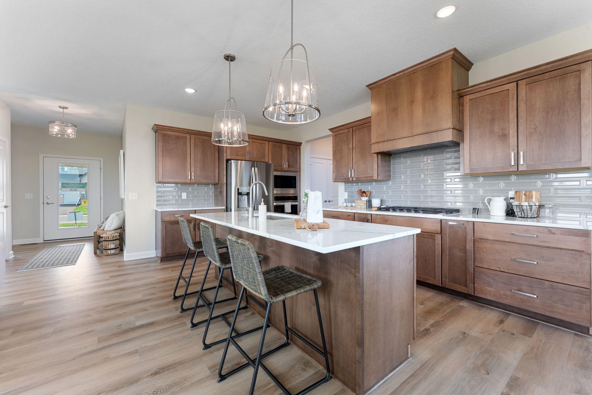 Gourmet kitchen with gas cook-top, wood hood (externally vented), built-in wall oven and microwave