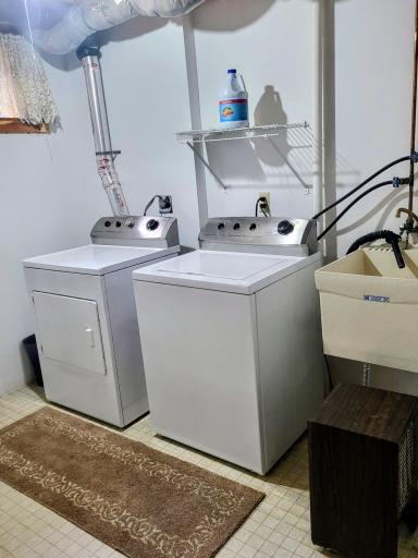 Laundry room in the lower level with a utility sink