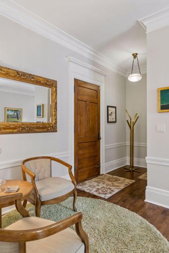 Foyer is a great space to hang coats and ample seating provides transition space