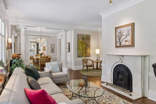Conversation area of living room with decorative marble fireplace