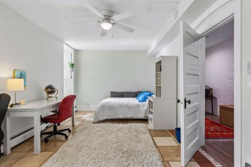 Huge second bedroom with tall windows overlooking sunken garden