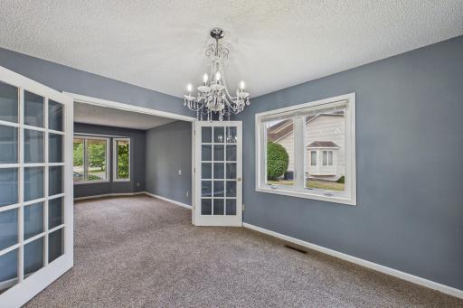 French doors seperate the living room and dining room