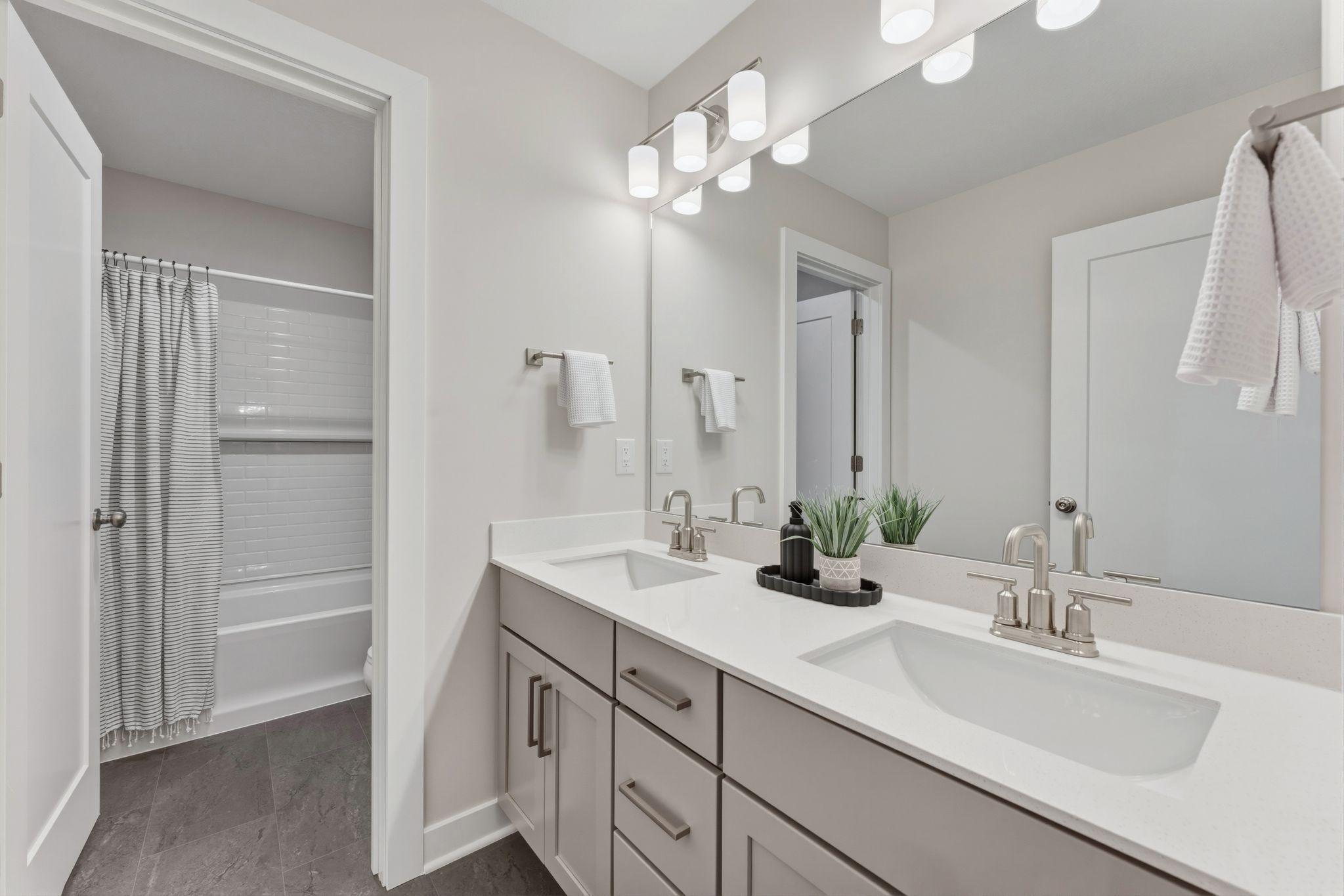 Upper level main full bathroom with dual vanities