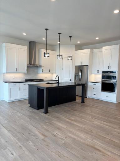 Ten foot ceilings with white cabinets and a stained island are dramatic!