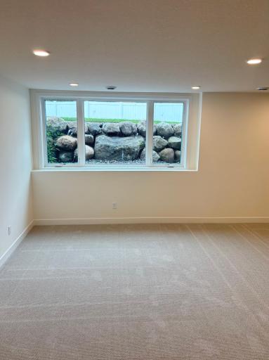 Lower level boulder retaining wall and window