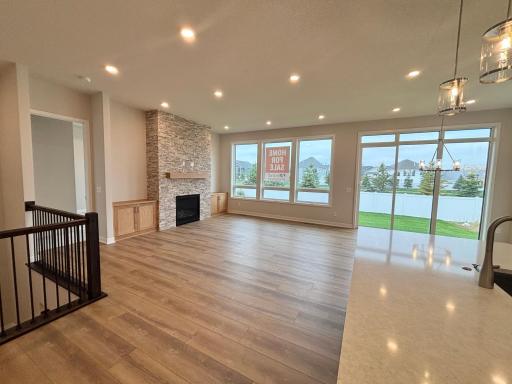 Living room with full stone fireplace and built-in cabinets