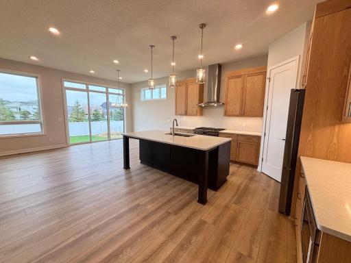 Gorgeous plank flooring throughout kitchen dining area, living room and entry hall.