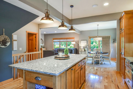 Pullout cabinets with undercabinet lighting and granite kitchen