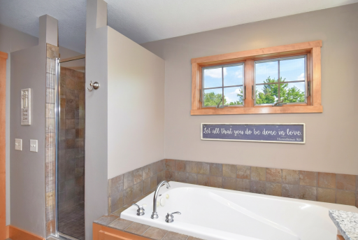 Primary bath jetted tub and separate tiled shower