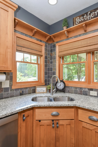 Corner kitchen sink with windows to porch area