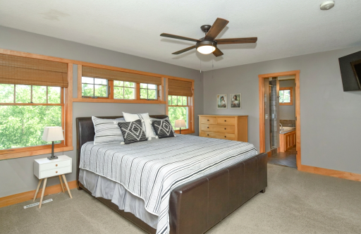 Primary upper level bedroom with full private bath and walk-in closet