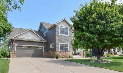 Wide concrete driveway, 4 car garage (tandem 2 car holds 4 vehicles) with floor drain, sink, and raised storage