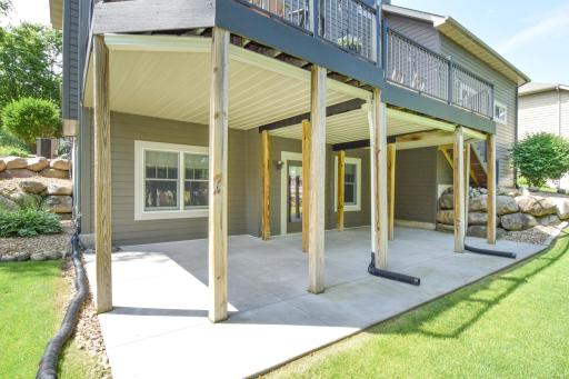 Walkout to concrete patio and treed backyard