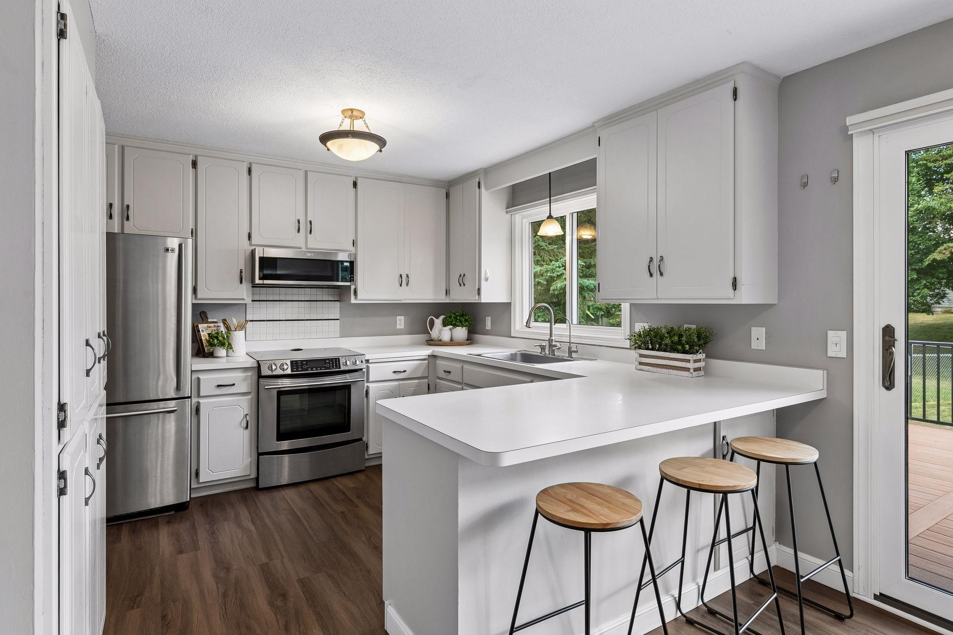Spacious Kitchen with stainless appliances, new microwave and sit-up counter.