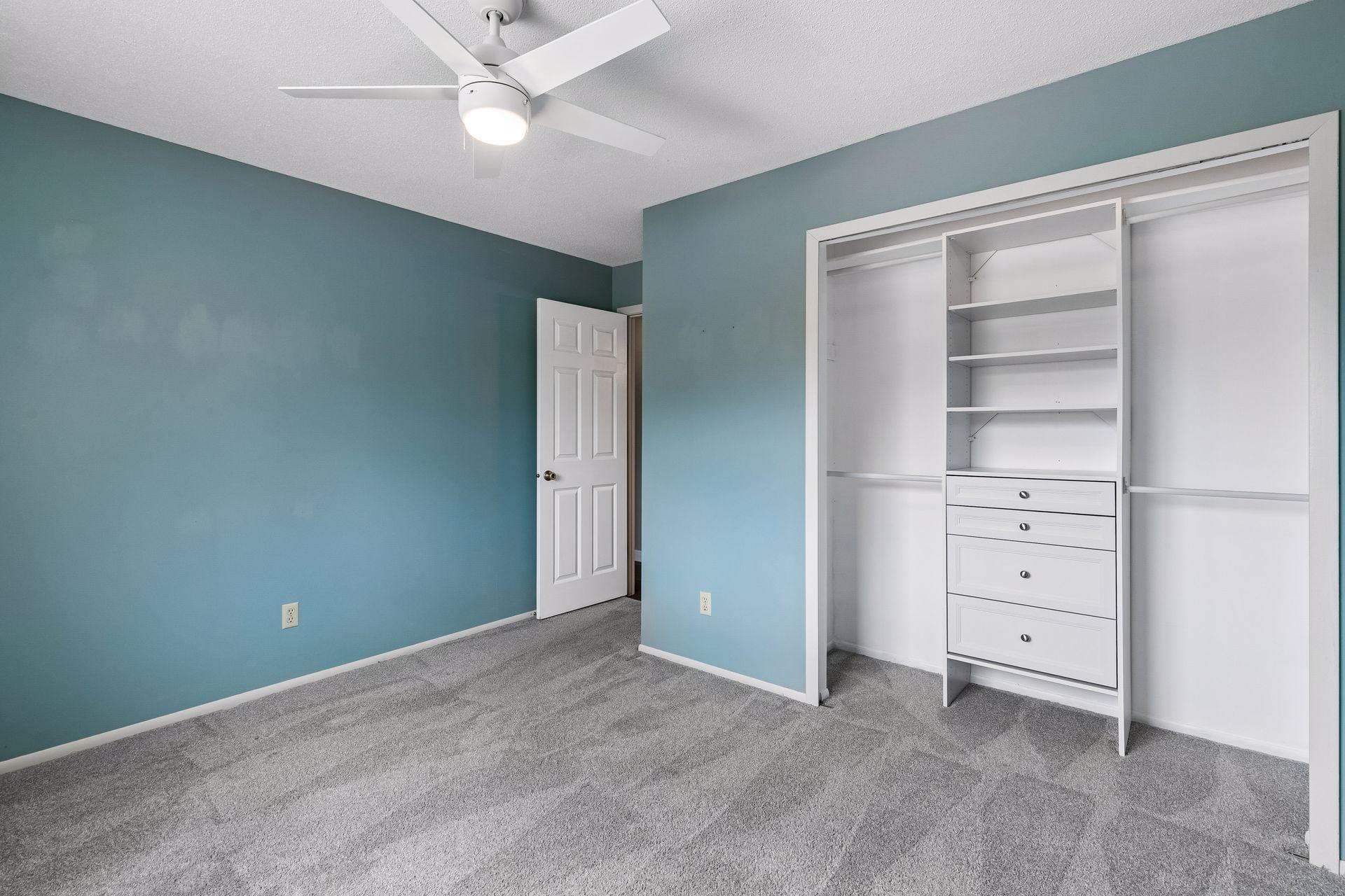Bedroom Two with closet organization. Closet lights and ceiling fans added by owner.