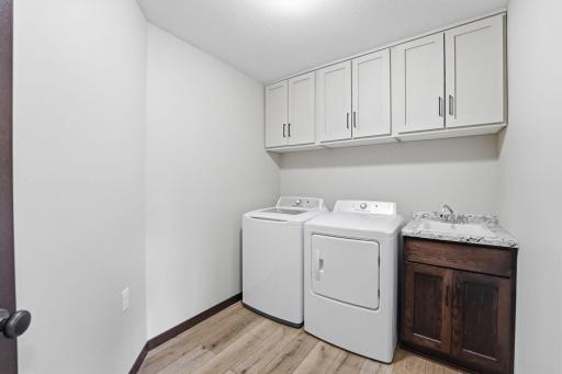 Laundry Room with an abundance of cabinetry, sink, washer dryer