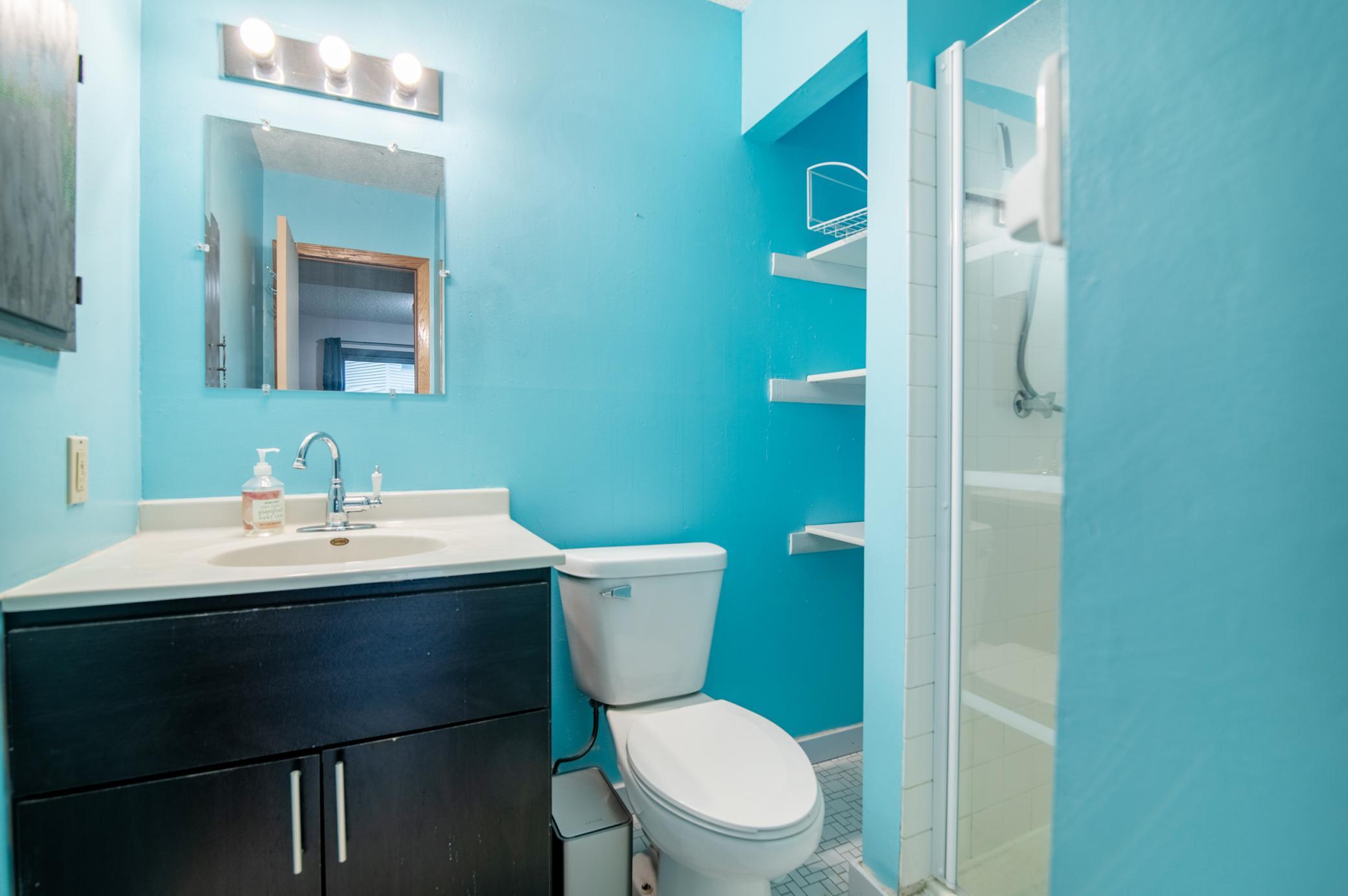 The lower level bath features a shower as well as additional linen space.