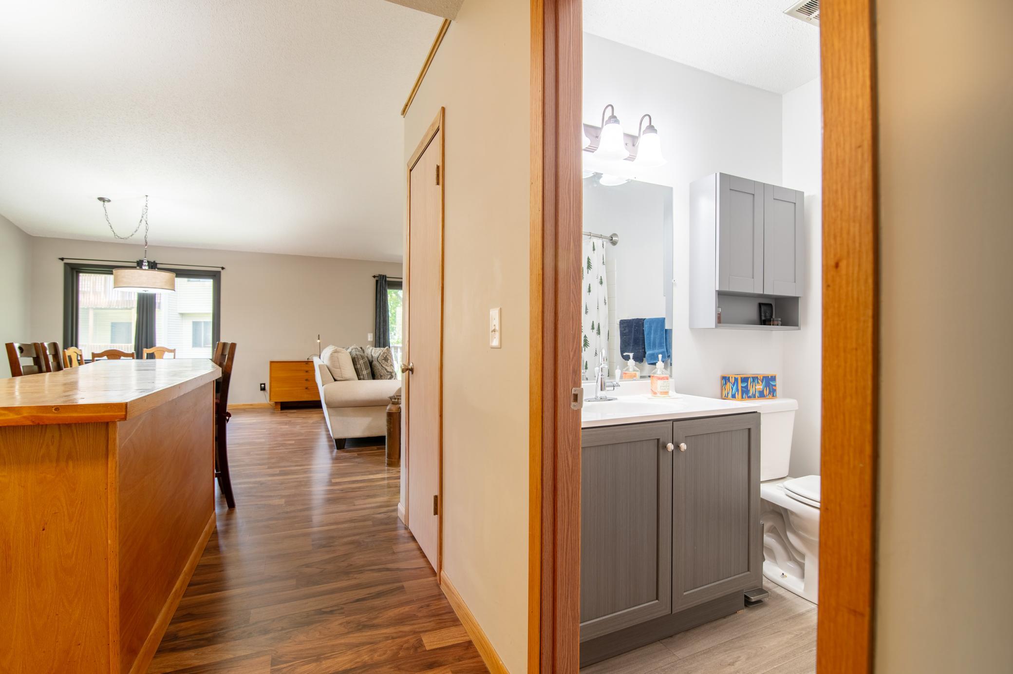 Sitting at the edge of kitchen is a main level full bath. Just behind the photographer is the hallway to the bedrooms.