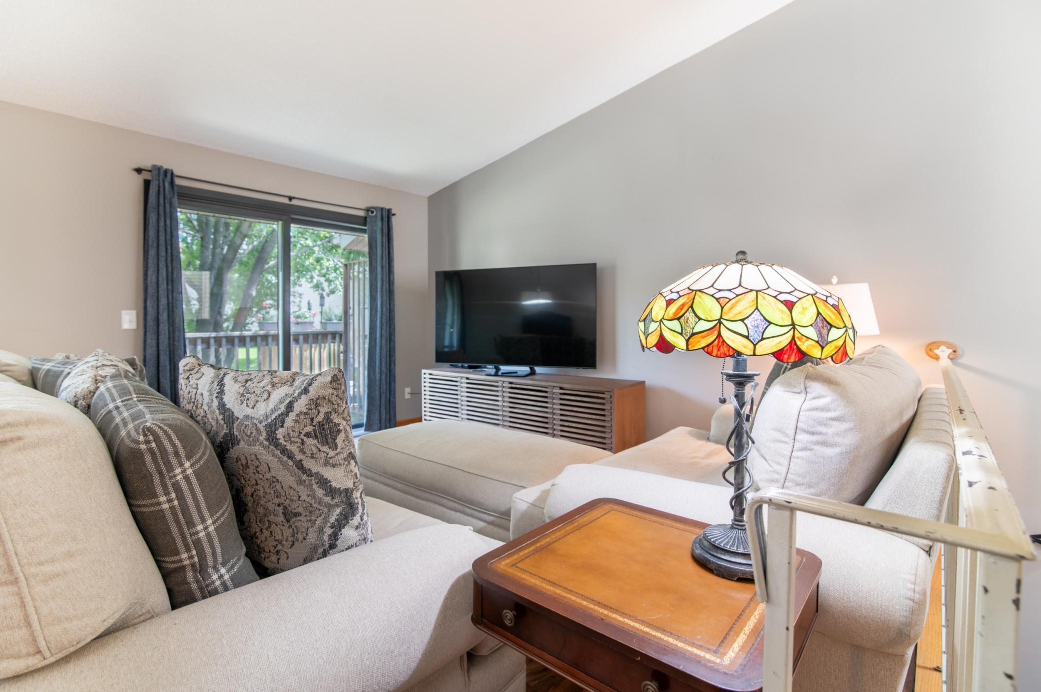 A small deck on the Northeast side of the unit is a comfortable and shady retreat. Open the sliding door for a nice breeze.