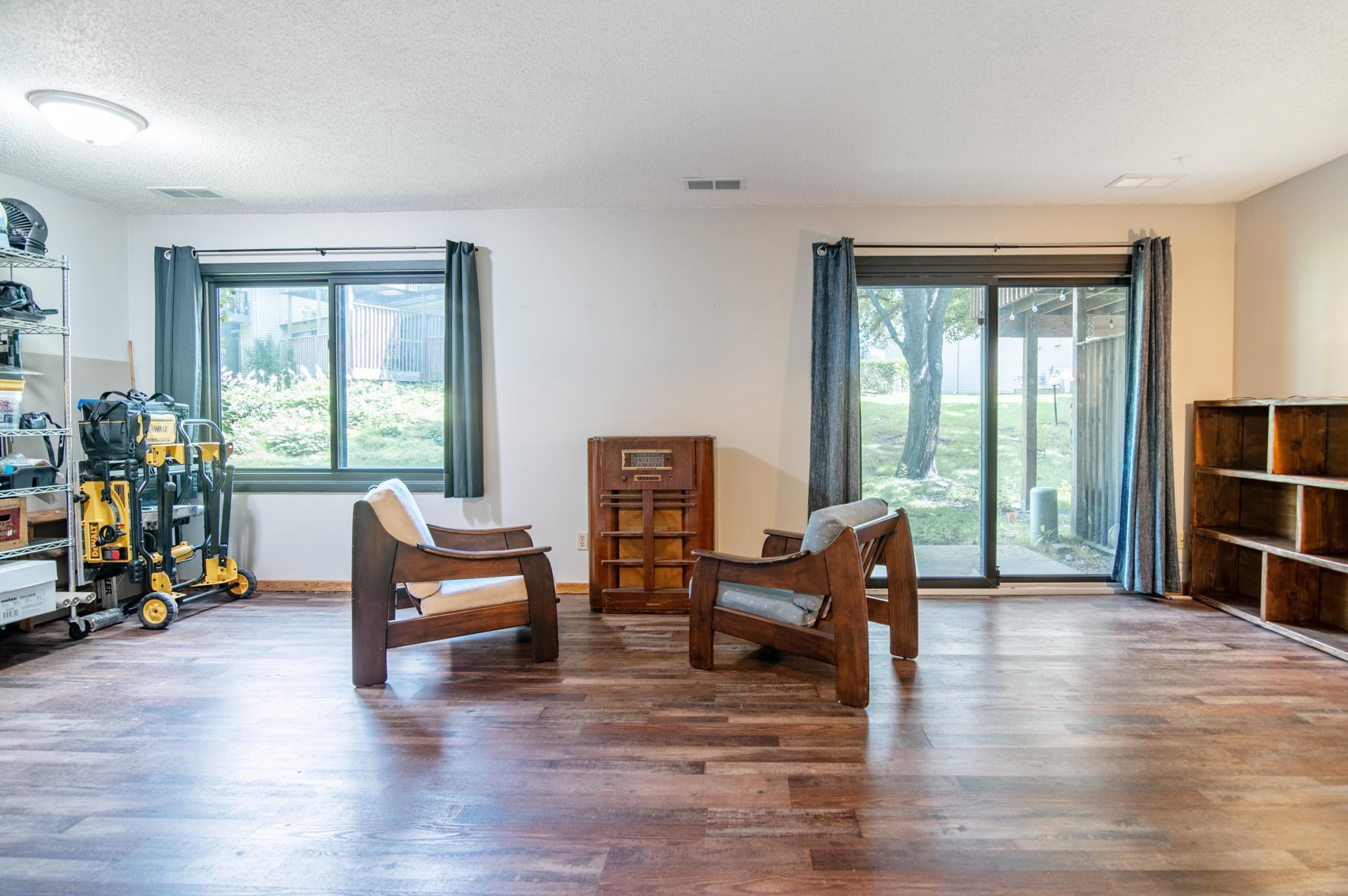 Just beyond the lower level sliding door is a small patio and a shady seating area provided by mature trees.