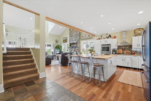 This stunning, custom kitchen has the island of your dreams, gas range, double oven and enless counter space